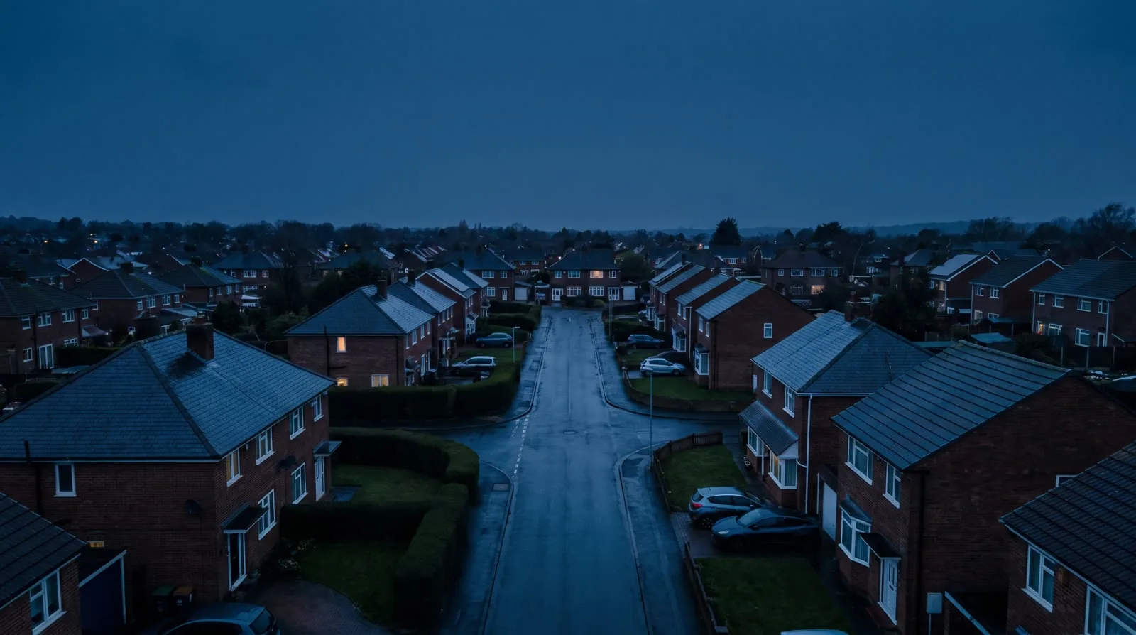 Rows of British homes seen from above shortly after sunset.